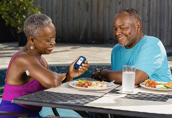 woman checking glucose monitor